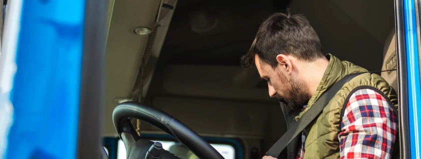 Driver wearing a seat belt behind the wheel