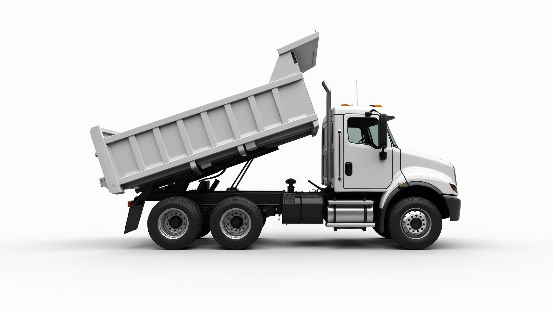 Dump truck with its bed raised and an aux-input widget pinned to the cab